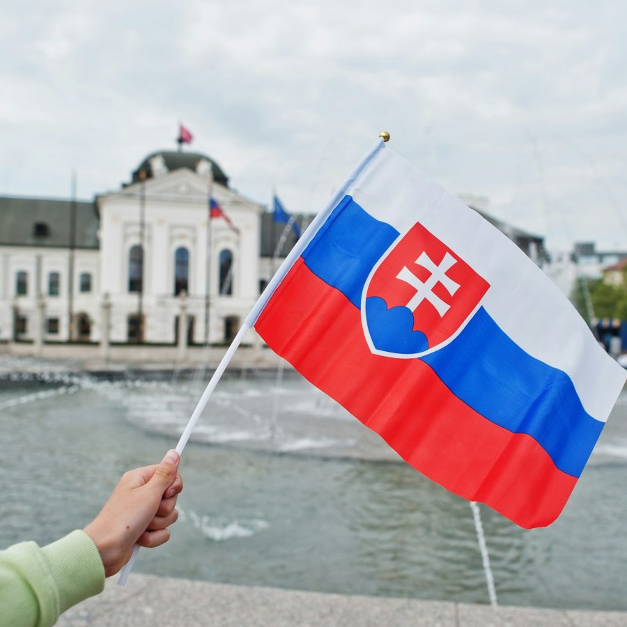 Flag of Slovakia against Grassalkovich Palace. Residence of the president of Slovakia in Bratislava.